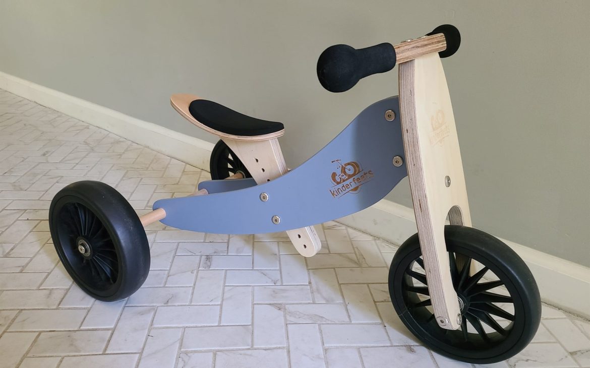 Kinderfeets Balance Bike sitting on tile floor. Another way to improve your green living lifestyle