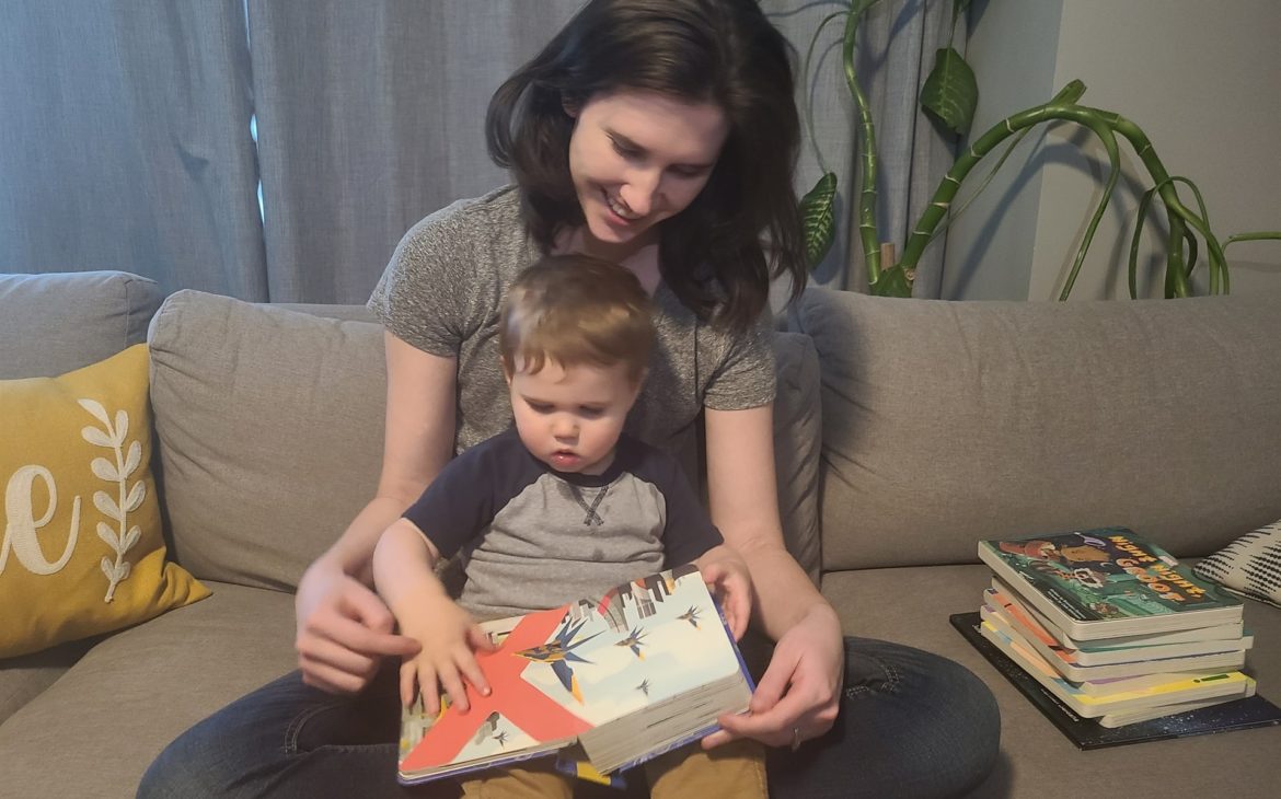 little boy and mom reading from their nerdy and eco-friendly baby books collection