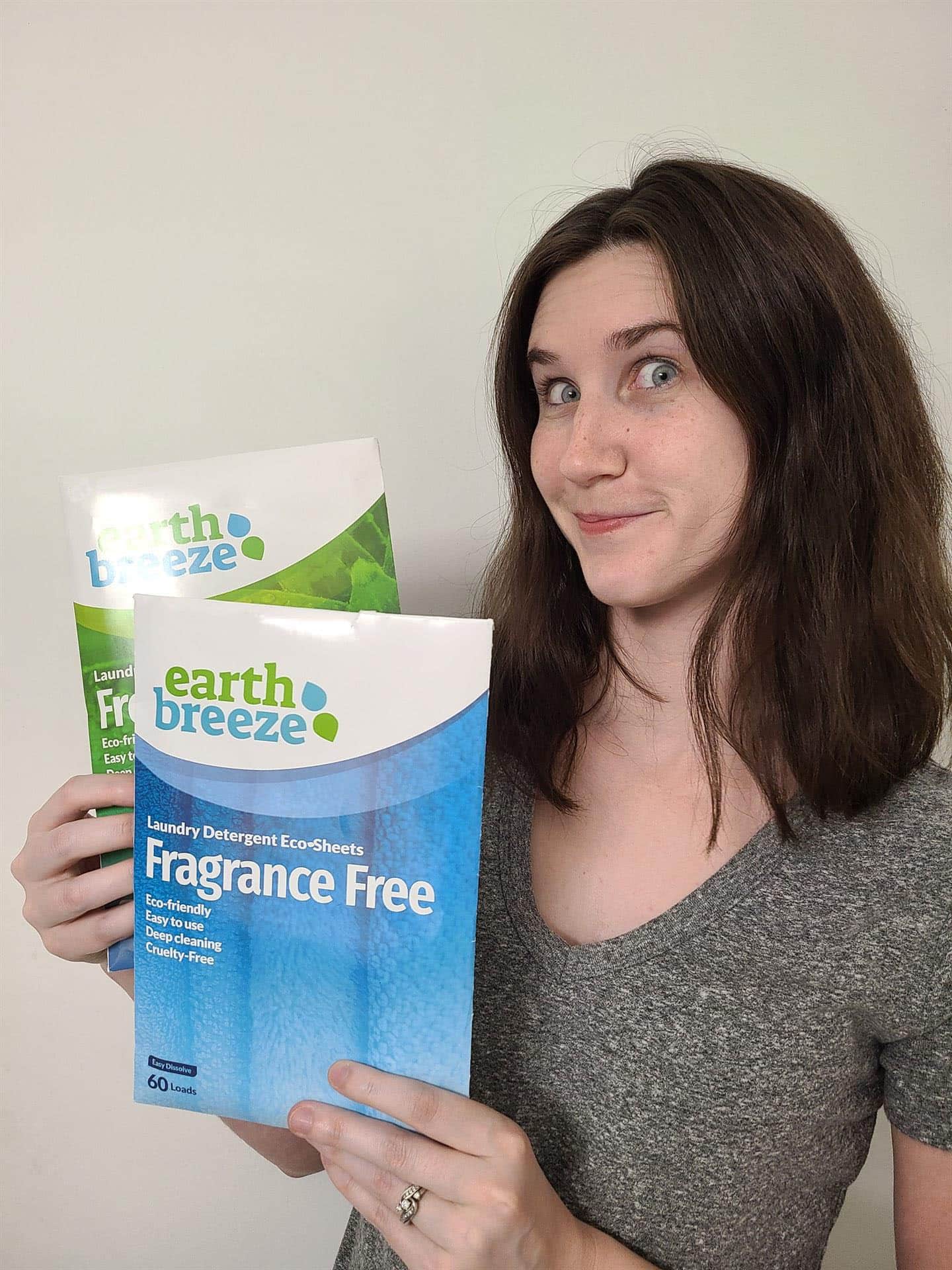 earth breeze review - best eco-friendly laundry detergent sheets being held by woman