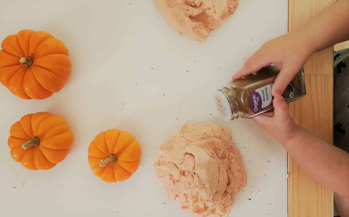 Adding spices to make fall scented homemade playdough