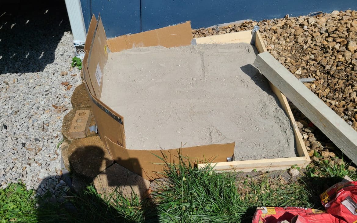 concrete pad laid out to hold a stacked rain barrel system