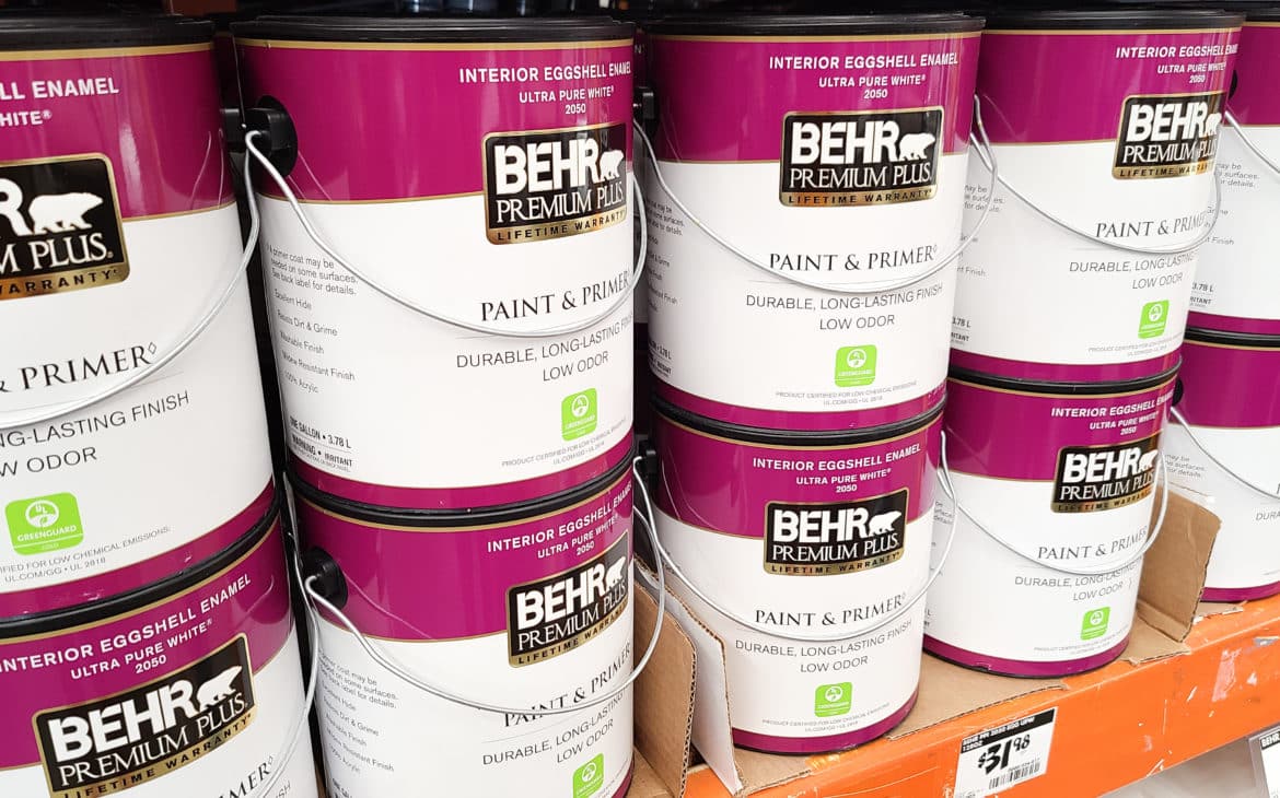 DIY sustainably using eco-friendly certified paint - showing behr premium plus paint cans on a shelf