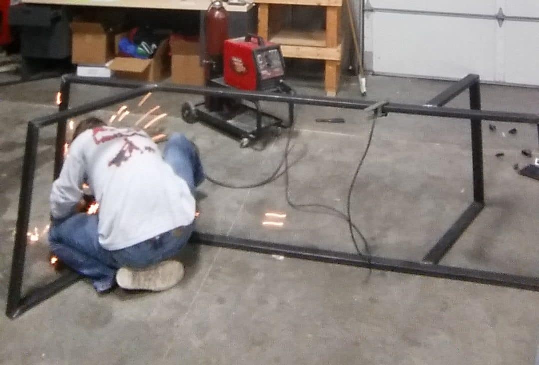modern table leg design being welded by a person