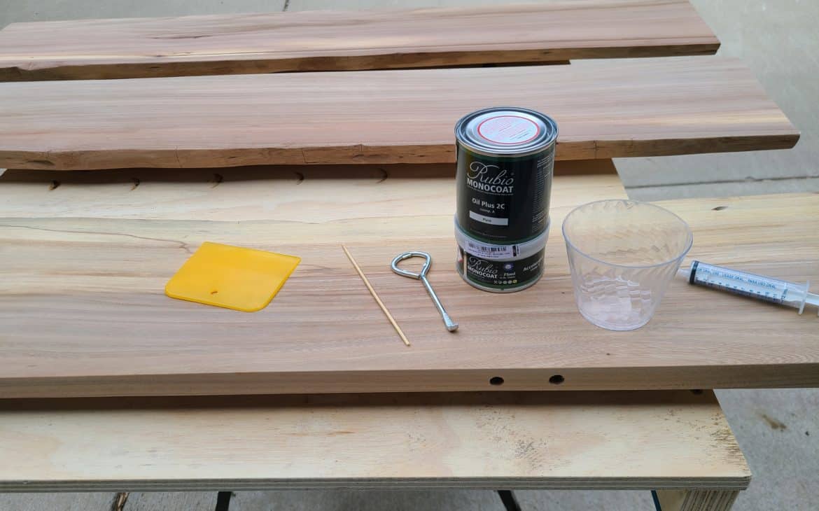 Rubio monocoat review - a can of rubio monocoat sitting with mixing tools on a wood board outside