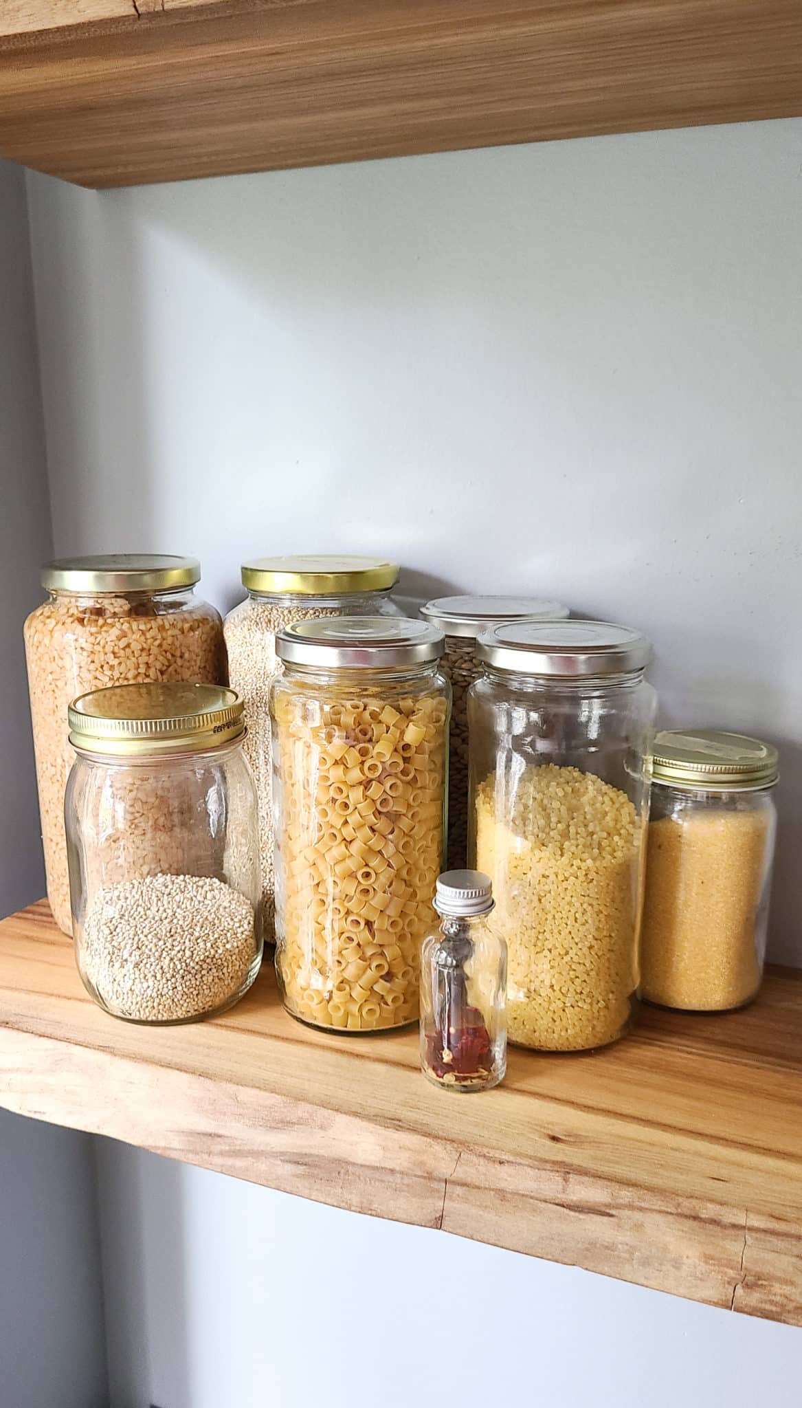 DIY organization idea - reusing emptied food jars for herbs and bulk storage