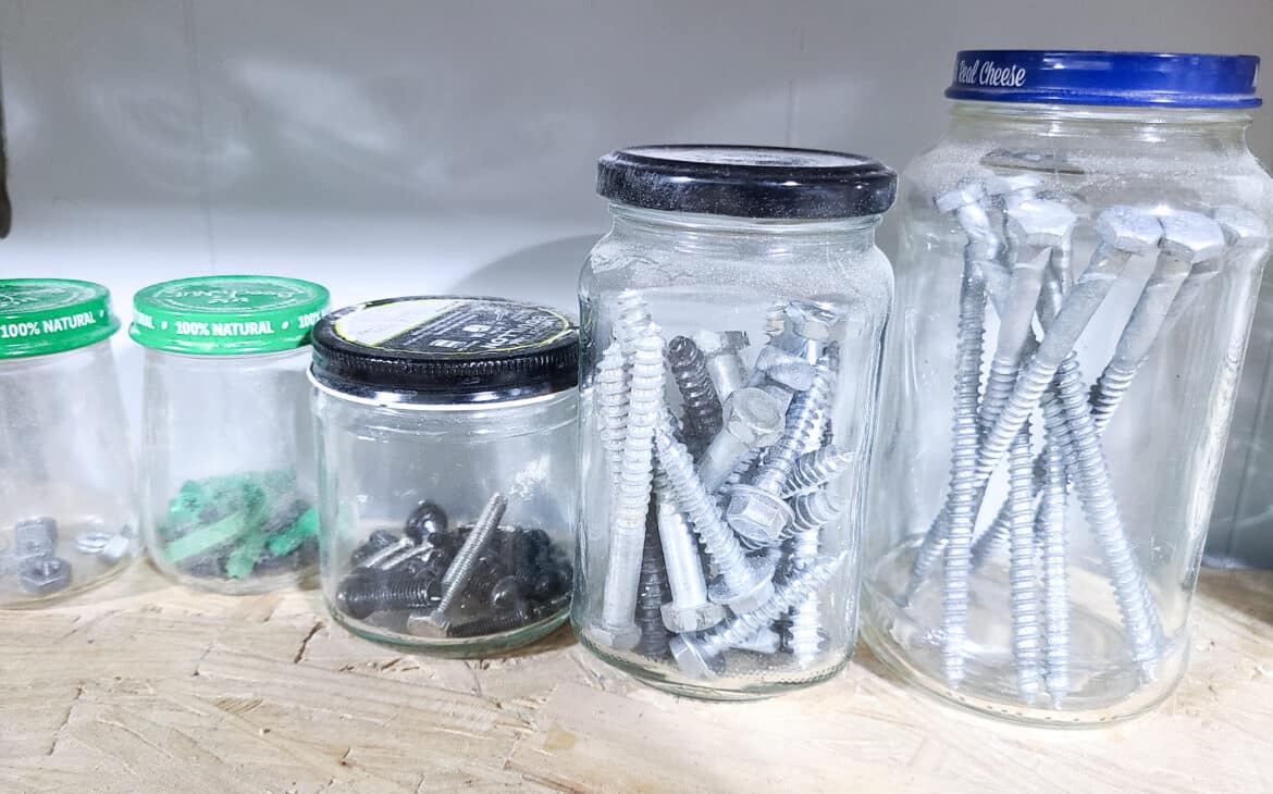 reused food jars to hold screws and small items helping organize a garage