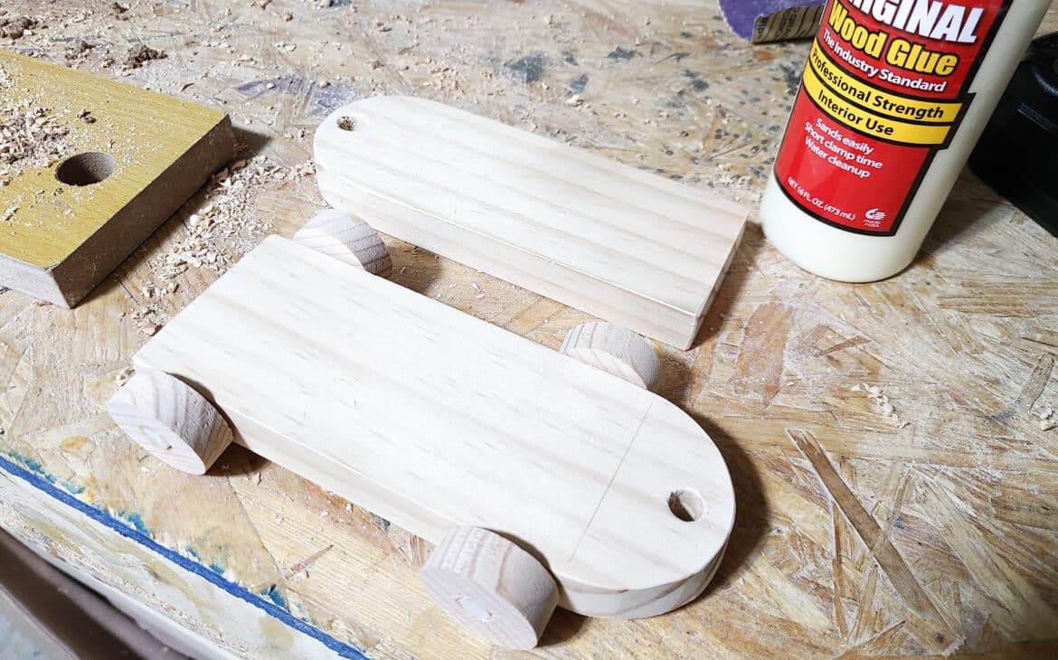 bases of a DIY wood train set sitting on a workbench