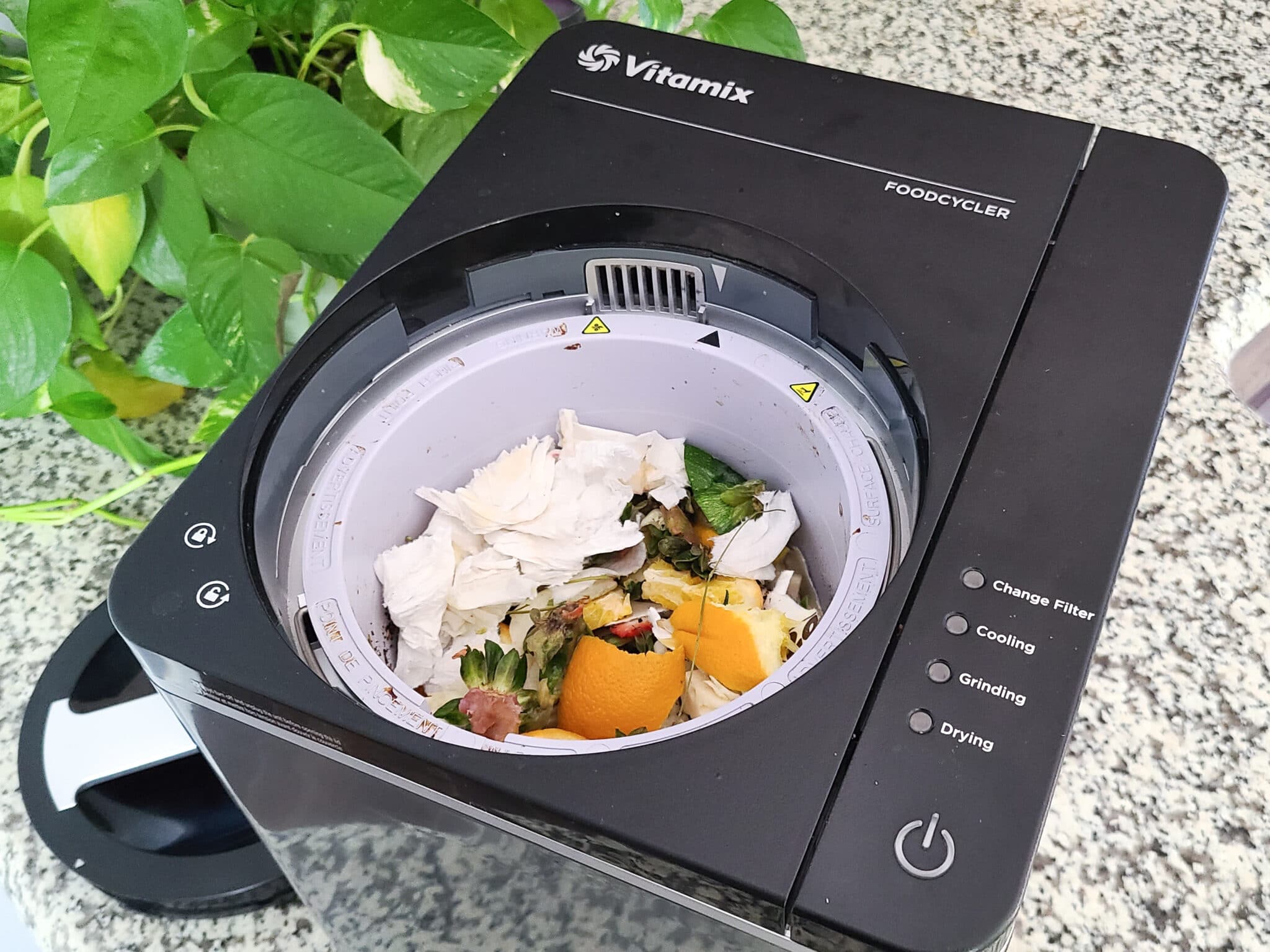 Shows Vitamix Foodcycler full of food scraps sitting on a kitchen countertop