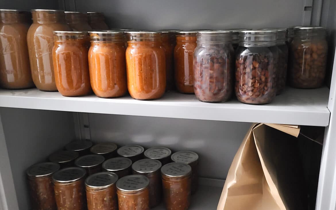 Gift for sustainability lovers - showing canning jars on a shelf full of preserved homegrown food