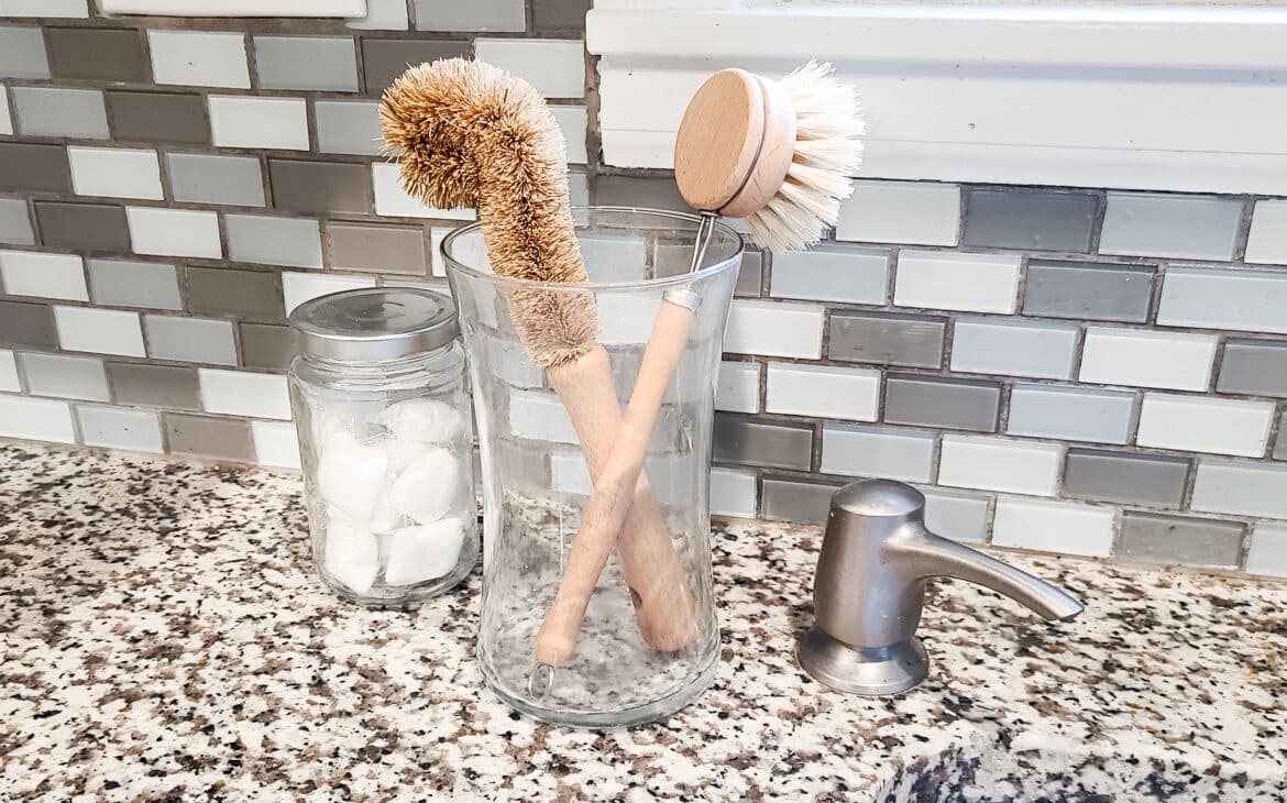 DIY organization idea - use decor items you already have for to organize like a vase to hold dish brushes