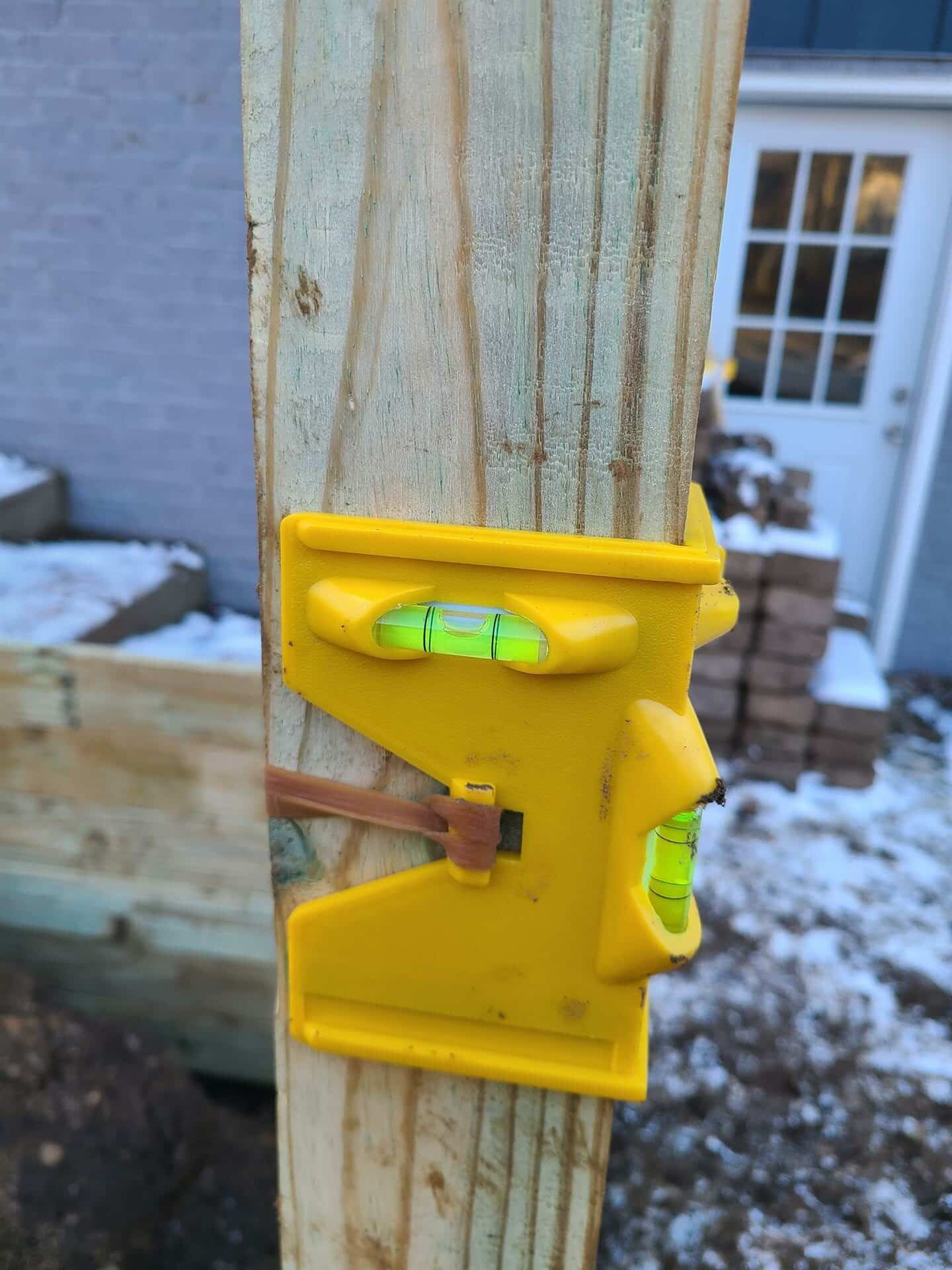 A post level on a wood post for a wood retaining wall