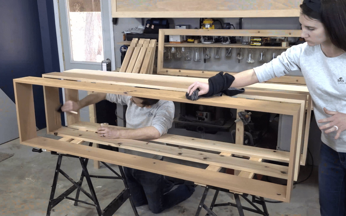 Two people applying the  Rubio Monocoat Hybrid Wood Protector onto wood planter box