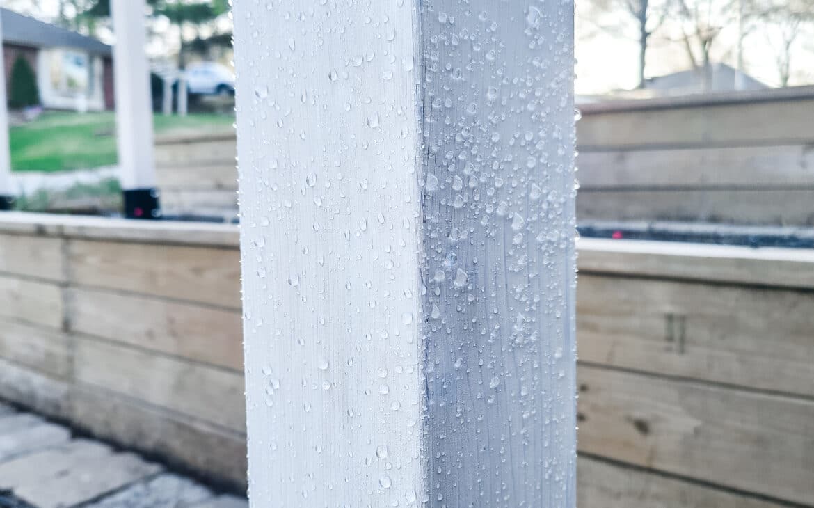 Showing the hydrophobic effect of Rubio Monocoat's WoodCream on a trellis post